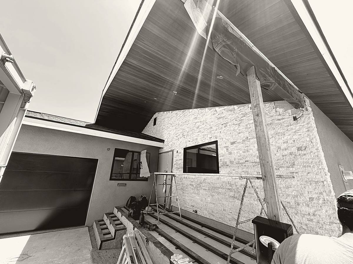 Stone and cedar facade under construction