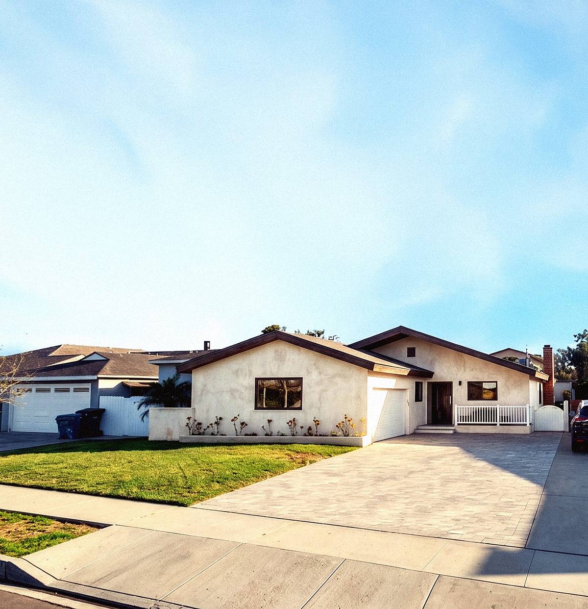 Renovated home with new concrete driveway at golden hour