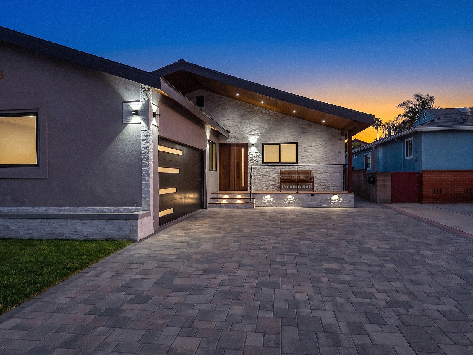 Hotta Residence entry and garage at dusk, stacked stone and paver drive, Torrance