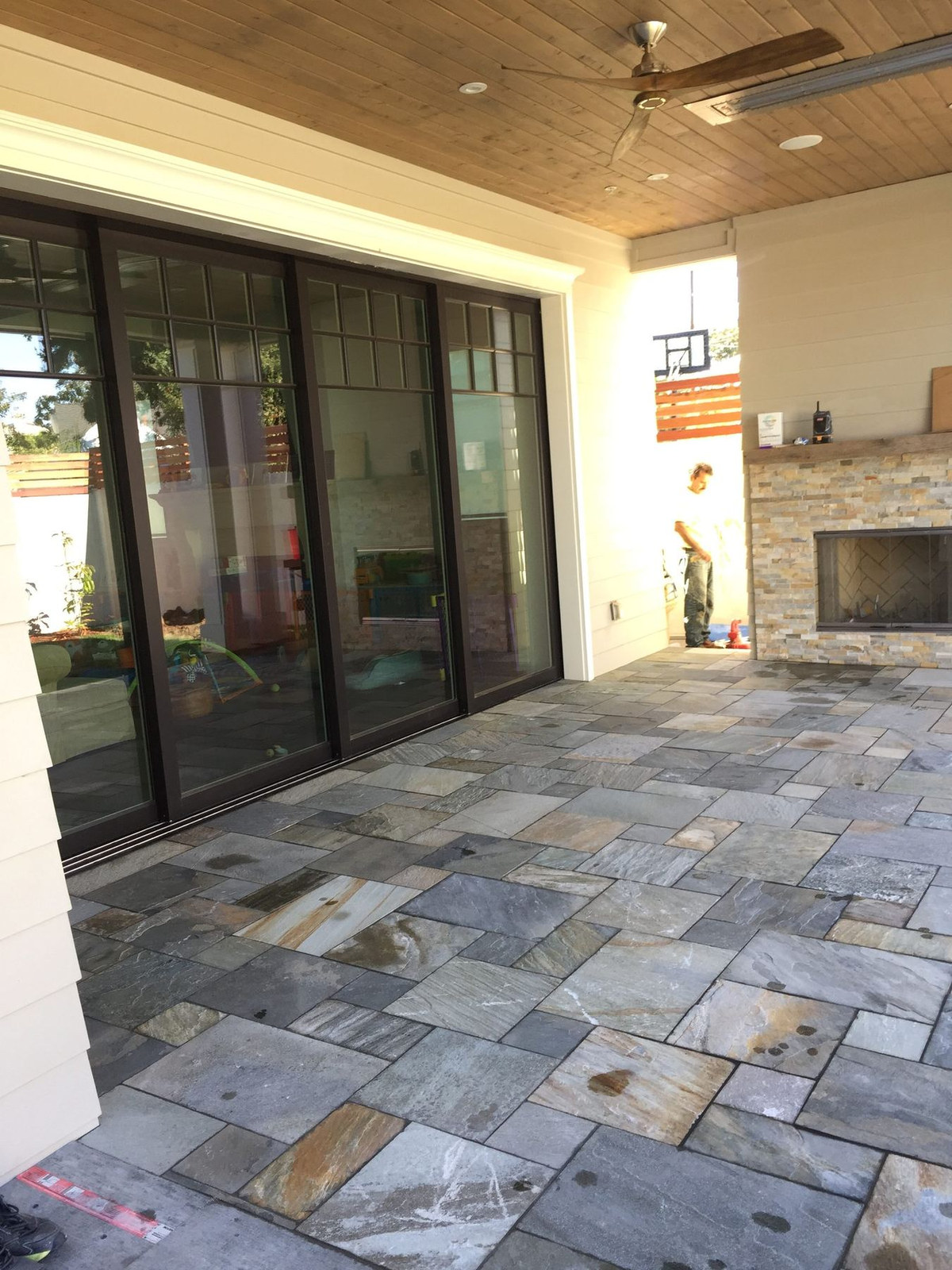 Covered stone patio and sliders, Ynes Residence